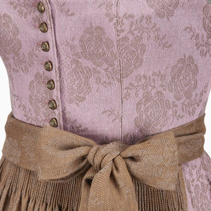 Close-up of a traditional outfit with a patterned top and brown belt.