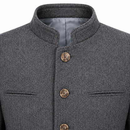 Close-up of a dark gray textured jacket with a mandarin collar, bronze buttons, and welt pockets on a white background.