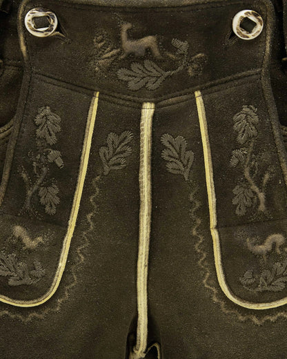 Dark fabric with embroidered patterns and decorative buttons