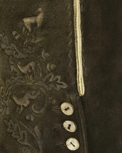 Close-up of a dark brown fabric with intricate embroidery and buttons.