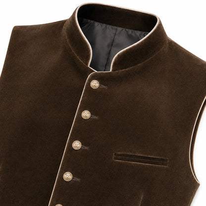 A close-up of a dark brown velvet waistcoat with a mandarin collar, decorative gold-tone buttons, and a welt pocket on a white background.
