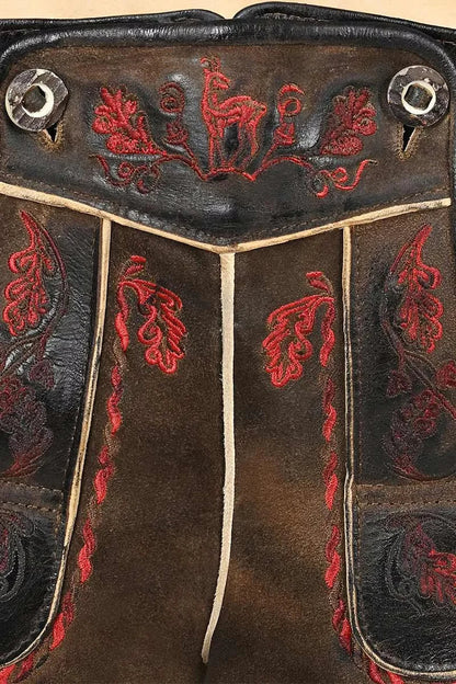 Close-up of a leather bag with red embroidery on a beige background