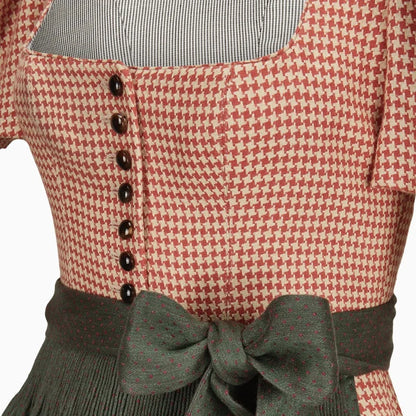 Red and white checkered dress with black buttons and green bow on a white background