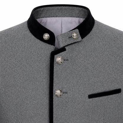 Close-up of a gray textured jacket with black velvet trim on the collar and front placket, plus decorative silver-tone buttons and a black pocket flap.