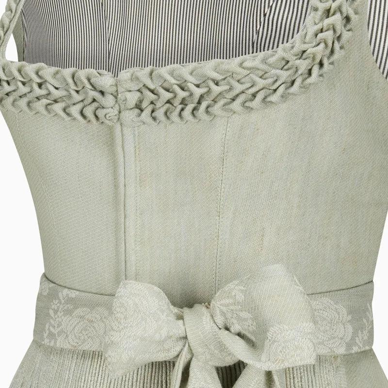 Light green apron with braided trim and a bow detail on a white background