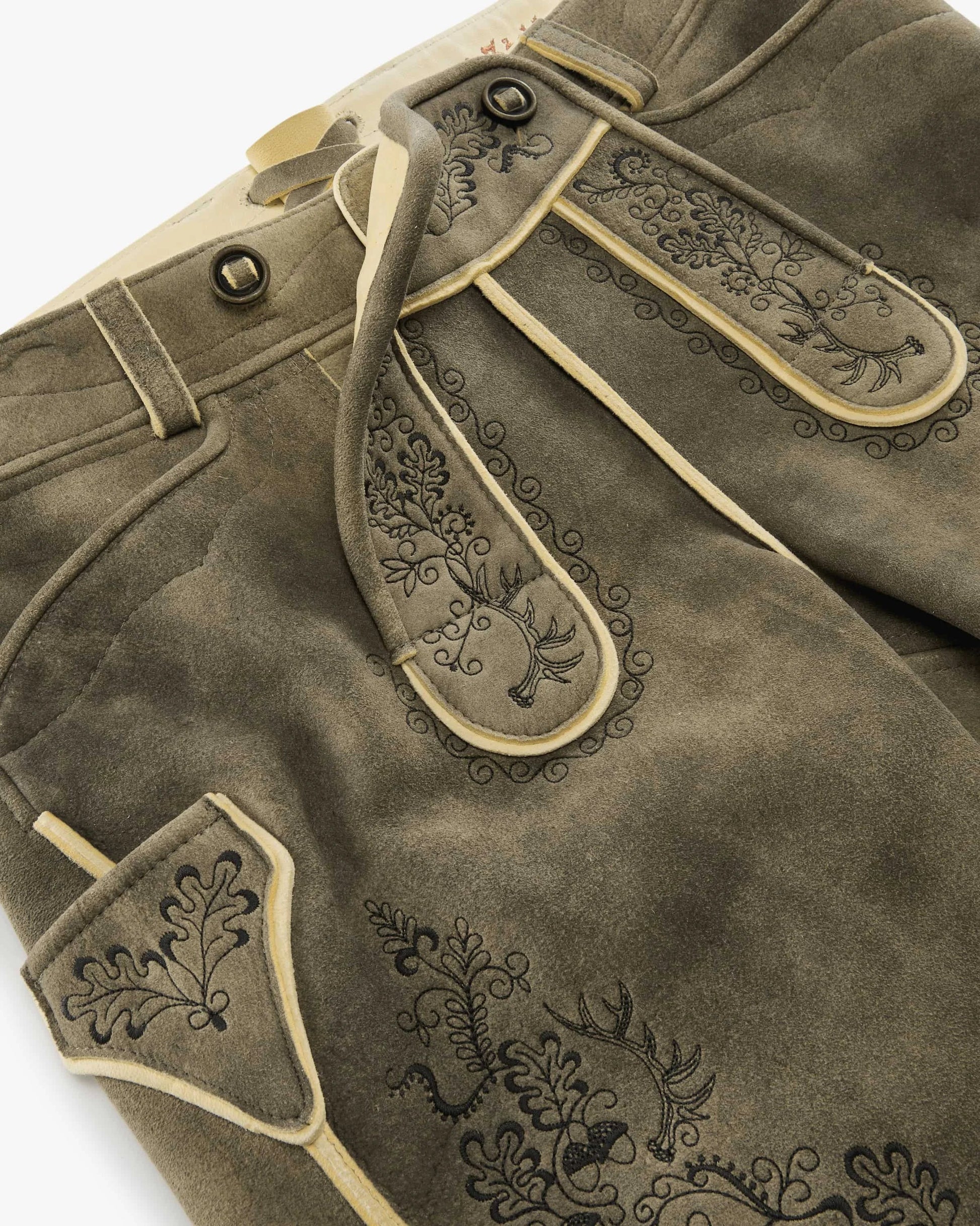Brown leather pants with decorative stitching on a white background