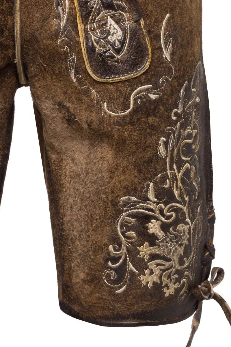 Close-up of brown leather boot with intricate gold embroidery on a white background