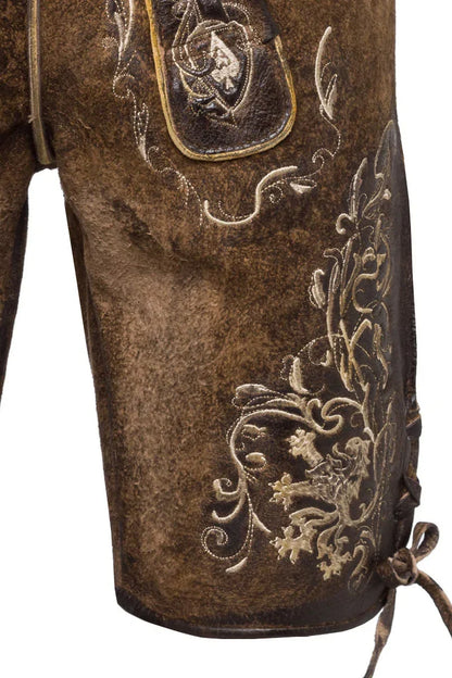 Close-up of brown leather boot with intricate gold embroidery on a white background