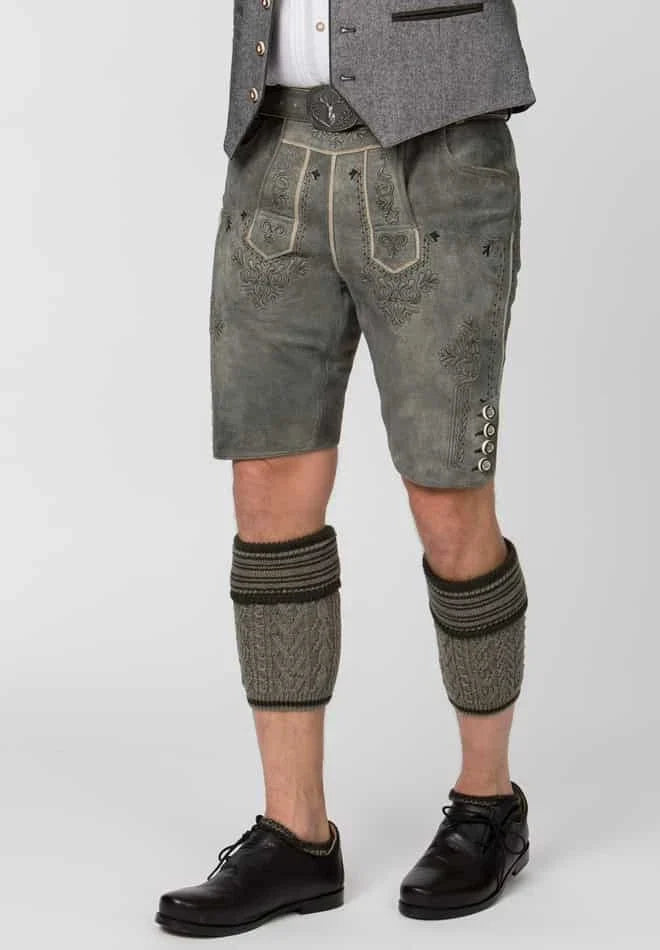 Person wearing traditional German lederhosen with a gray jacket on a white background