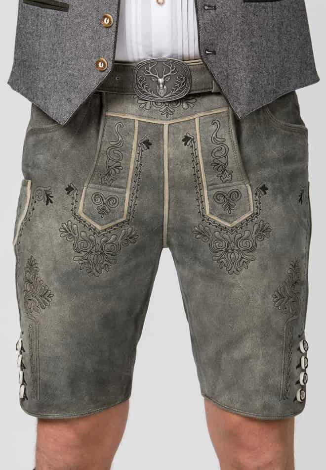 Traditional German lederhosen with intricate embroidery on a plain background