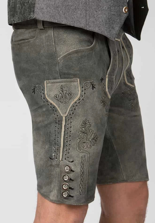 Traditional leather shorts with embroidery and buttons on a plain background