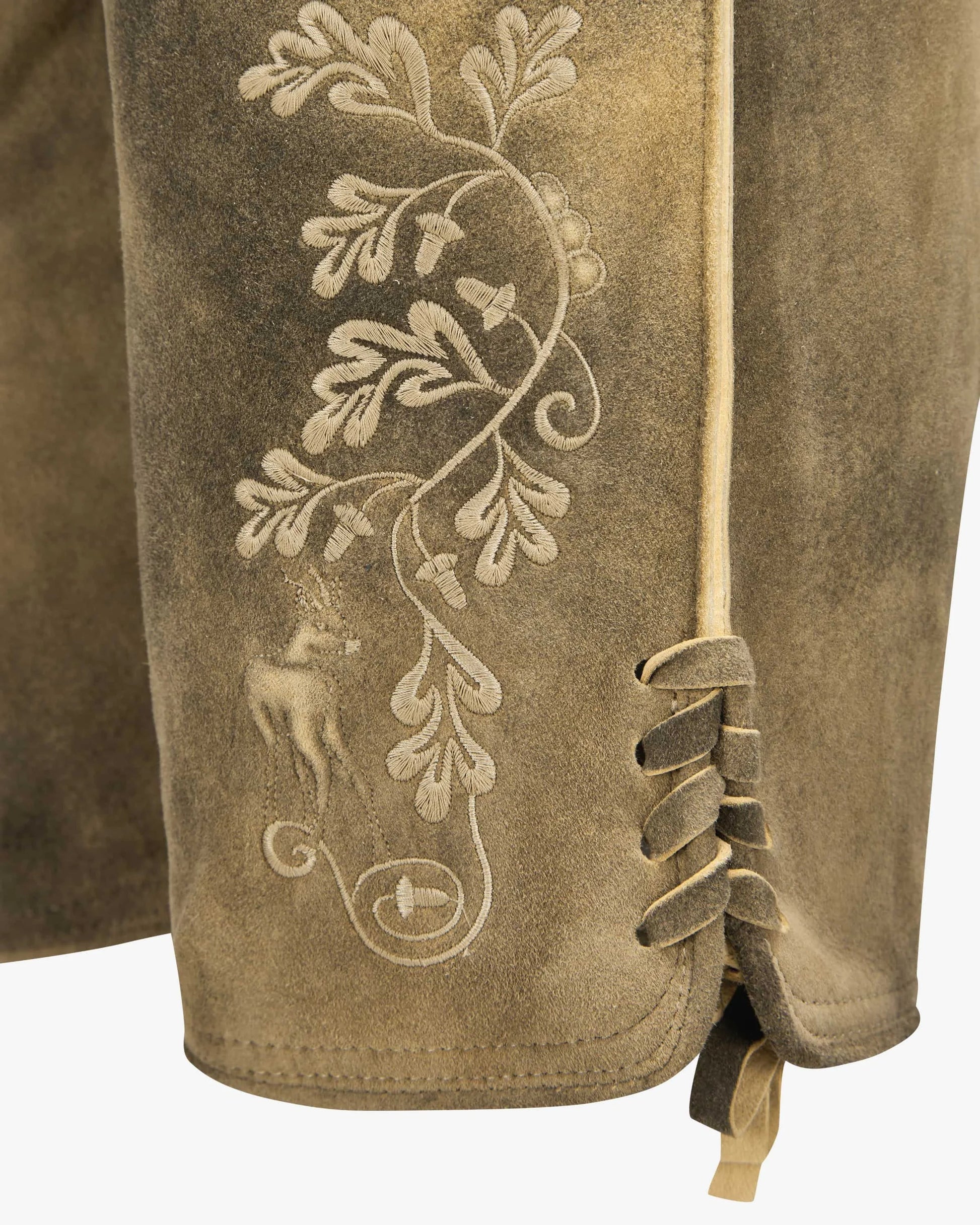 Brown leather glove with intricate white embroidery of a deer and leaves on a white background