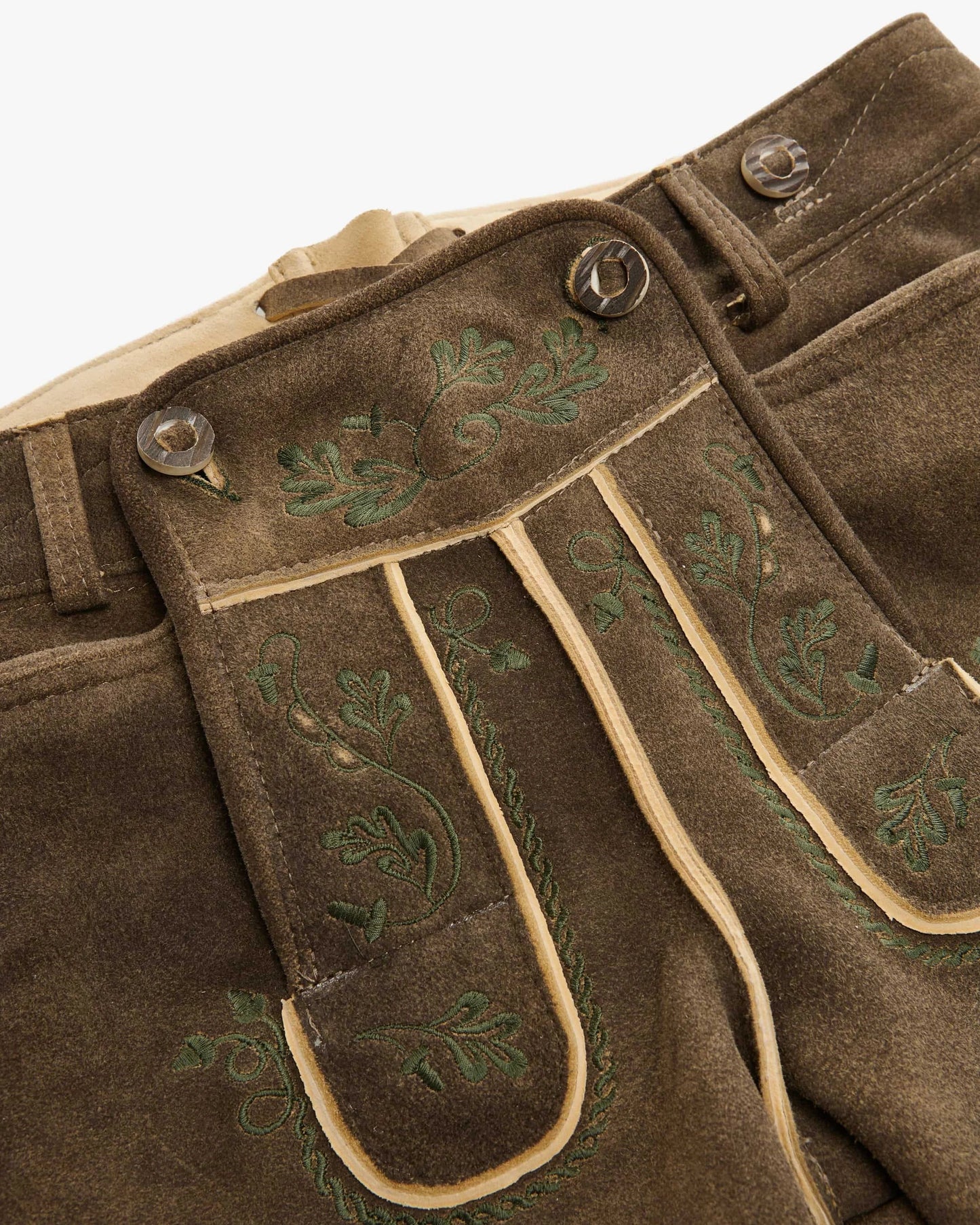 Brown pants with green embroidery on a white background