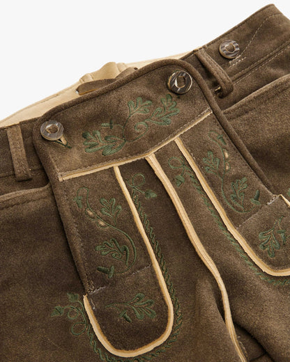 Brown pants with green embroidery on a white background