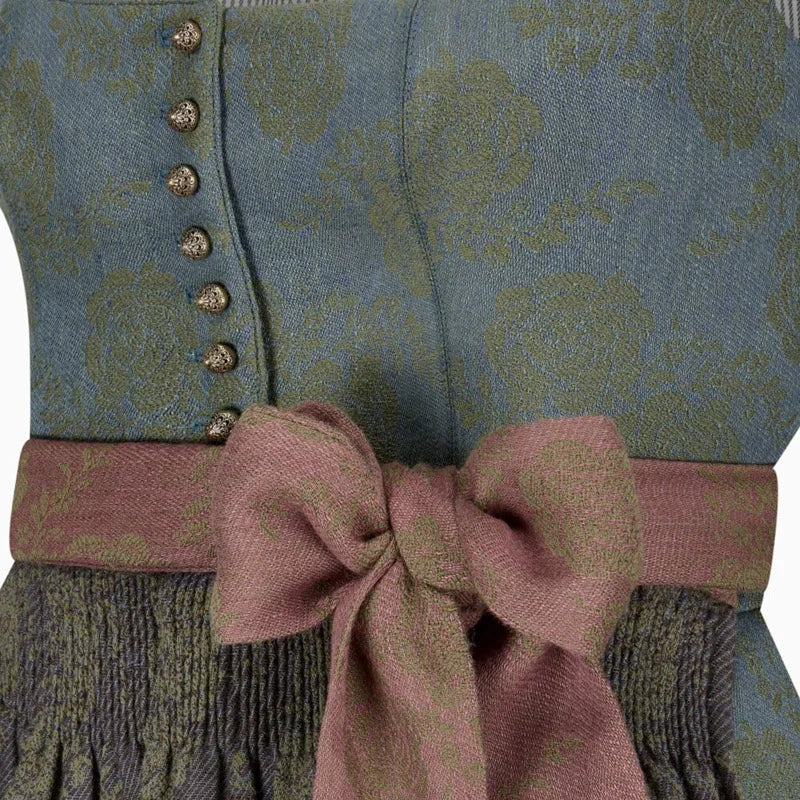 Close-up of a patterned garment with a pink bow and buttons.