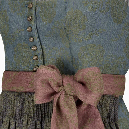 Close-up of a patterned garment with a pink bow and buttons.