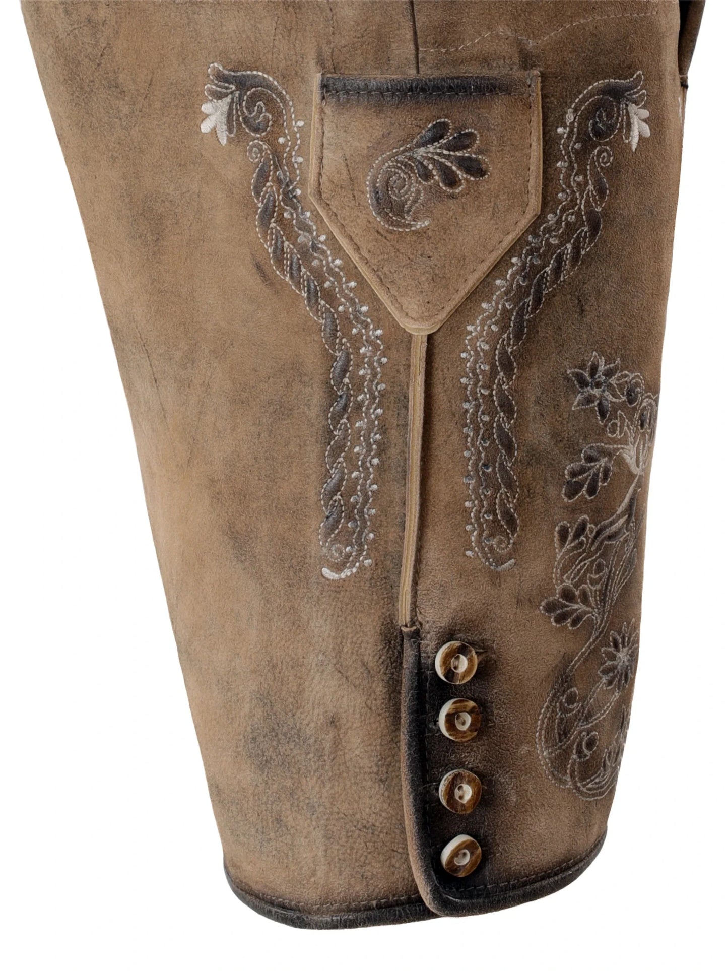 Close-up of brown leather pants with intricate embroidery and button details on a white background
