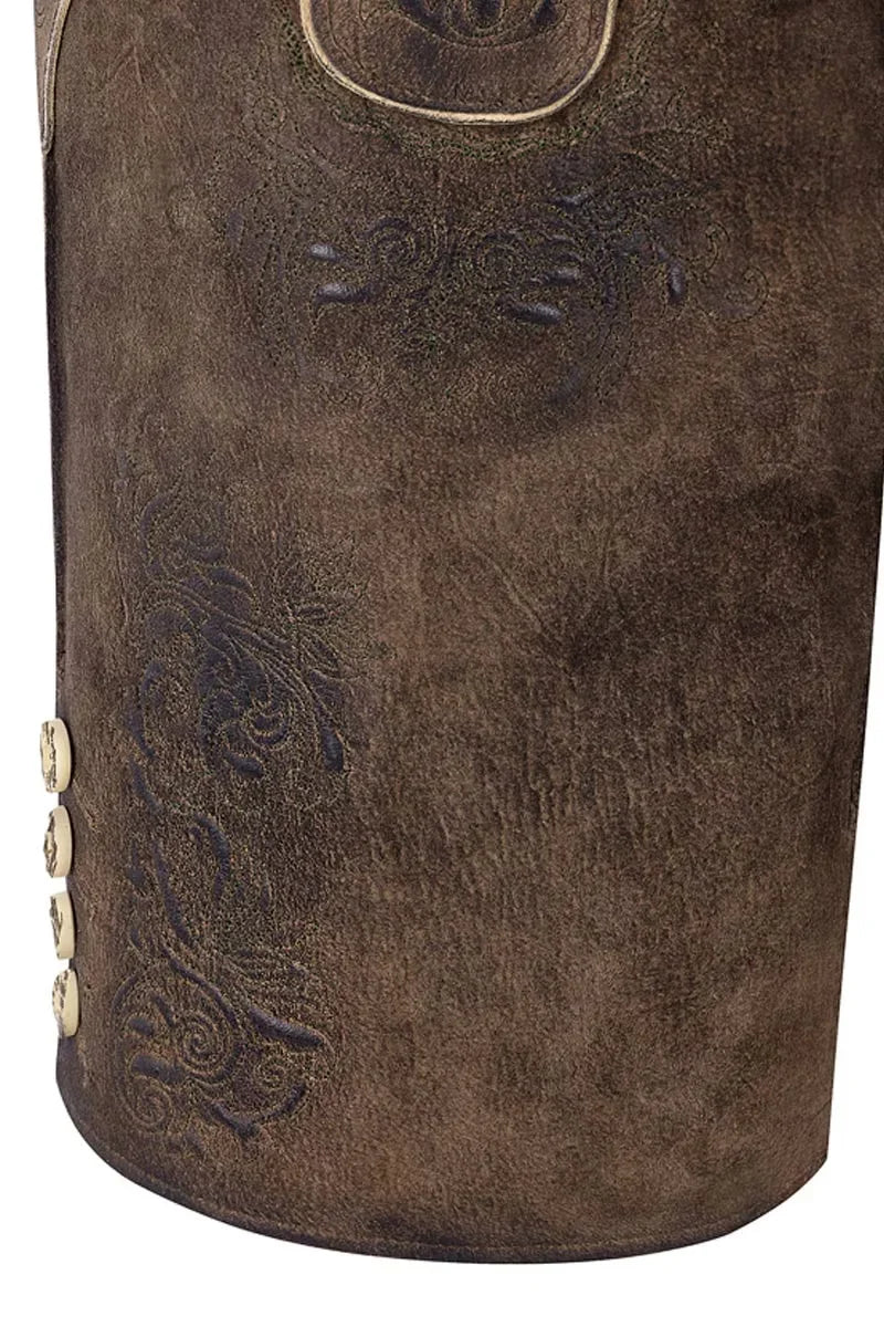 Close-up of a brown leather bag with intricate designs and gold buttons on a white background