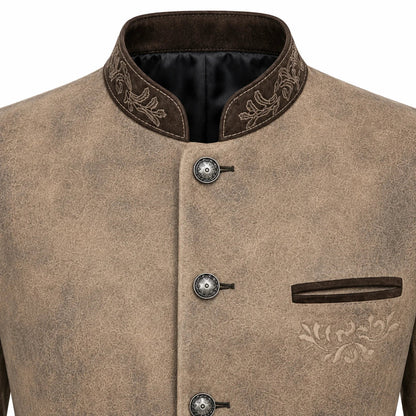 A close-up of a men's traditional jacket featuring a textured taupe-brown body, dark brown mandarin collar with floral embroidery, decorative metal snap buttons, and a matching dark brown welt pocket on the chest.