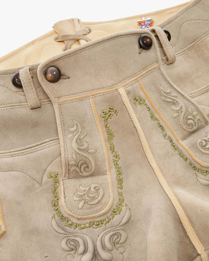 Traditional German lederhosen with embroidery on a white background