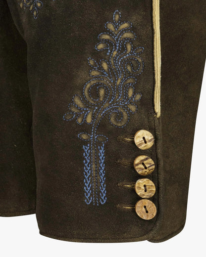 Brown fabric with embroidered design and wooden buttons on a white background