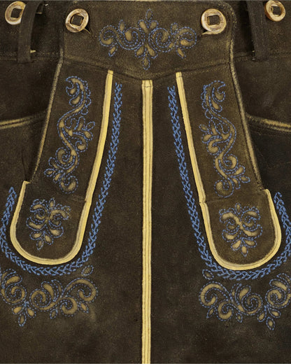 Brown leather pants with blue and gold embroidery and grommets.
