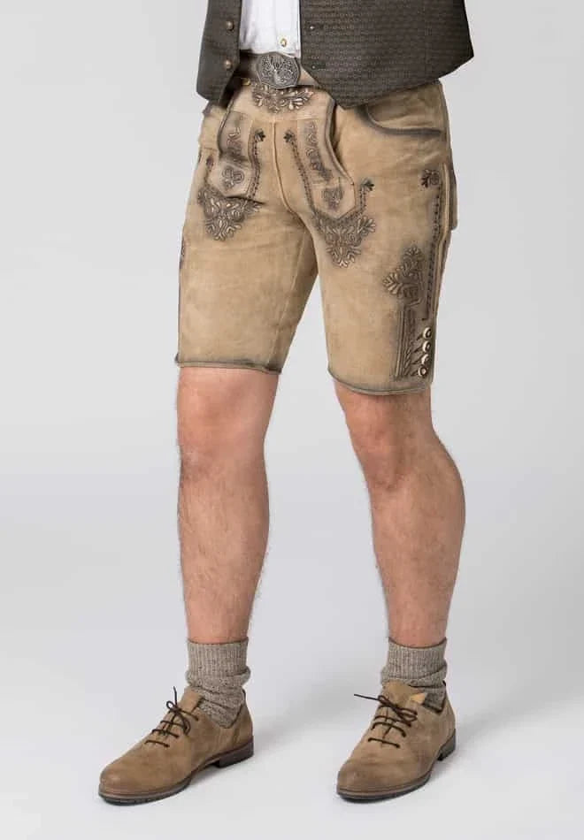 Person wearing traditional Bavarian lederhosen with decorative elements on a white background
