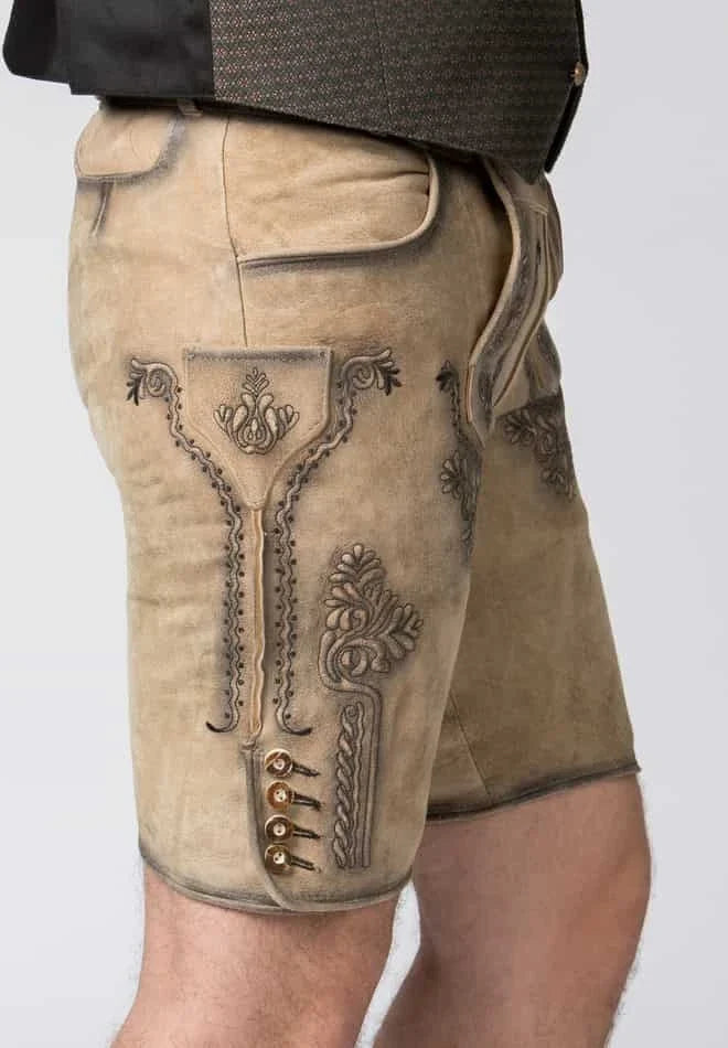 Beige shorts with intricate embroidery on a plain background