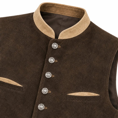 Close-up of a dark brown waistcoat or vest with a tan collar, decorative silver-toned buttons, and matching tan trim on the pocket edges, shown against a white background.