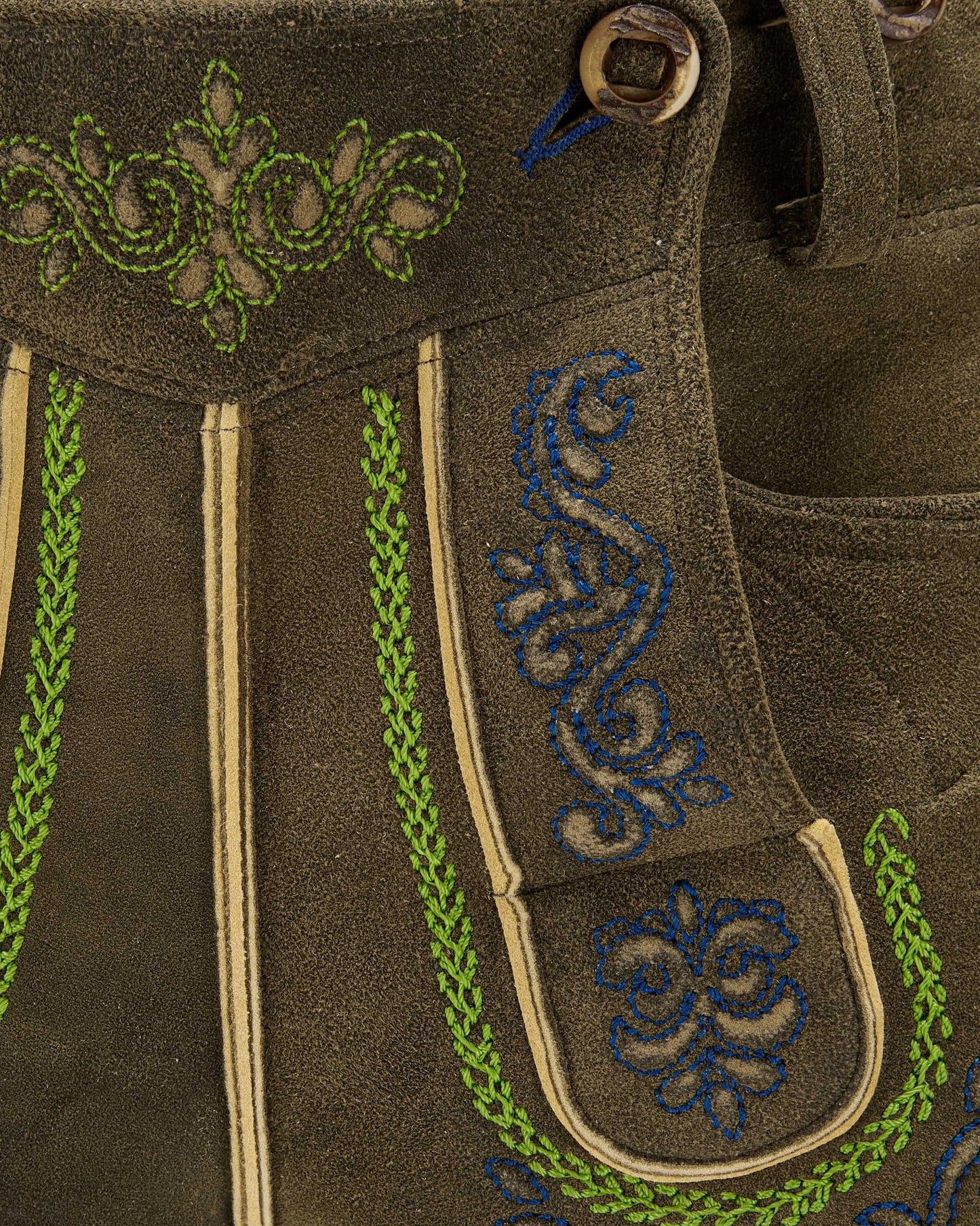 Brown fabric with green and blue embroidery details