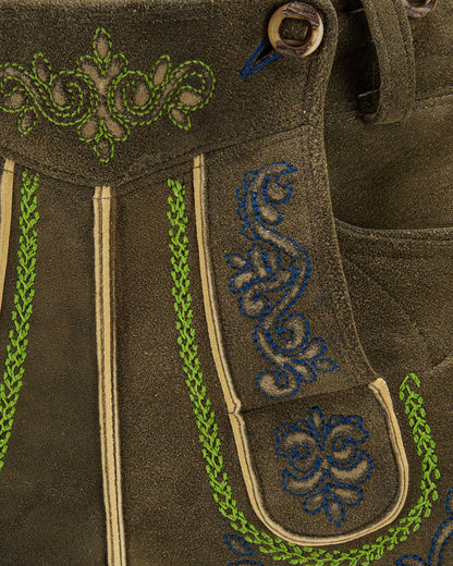Brown fabric with green and blue embroidery details