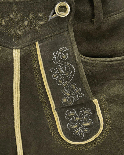 Close-up of dark brown leather with intricate white embroidery on a strap.