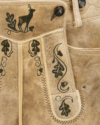 Close-up of a brown leather vest with black embroidered designs