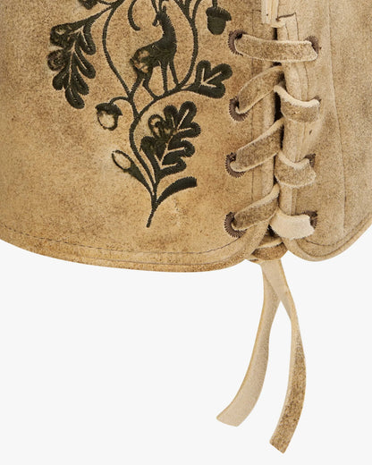 Close-up of a brown leather vest with black embroidered designs